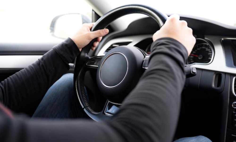 man-hands-driving-steering-wheel_188913-1279