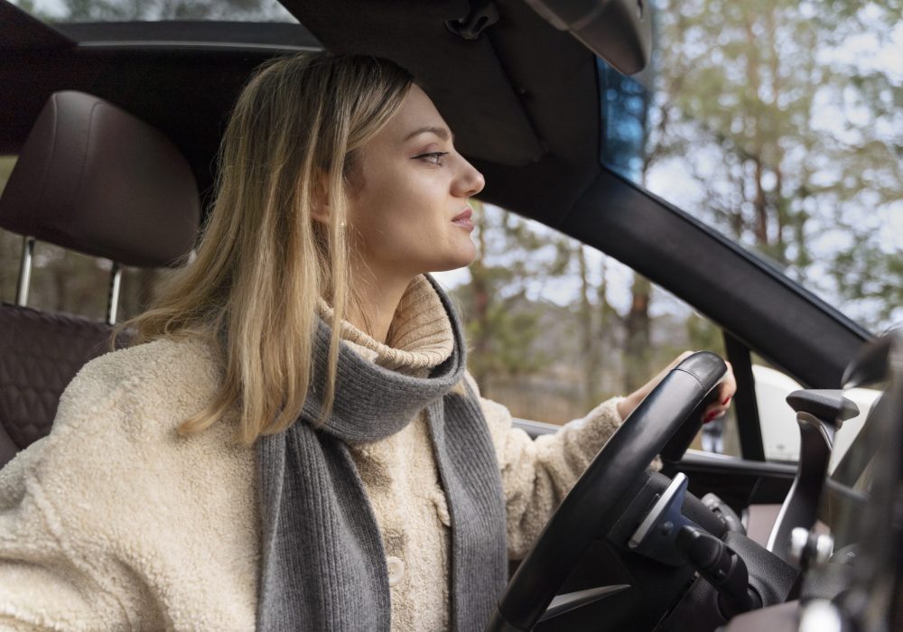 young-woman-driving-car-while-traveling